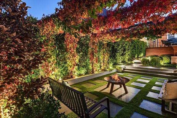 outdoor fire pit and arbour with steppers in lawn